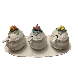 Vintage set of three Capodimonte porcelain condiment jars with spoons, sitting o